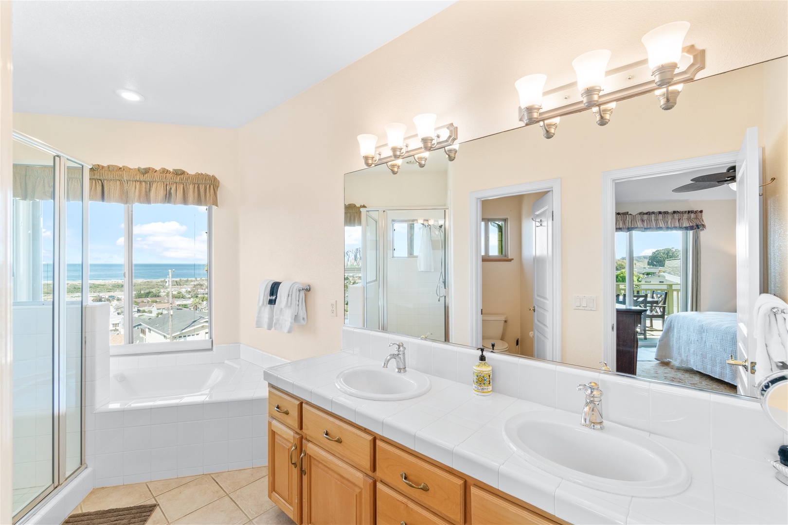 Master bathroom features a step in shower, jacuzzi tub, and double sink counter top. 