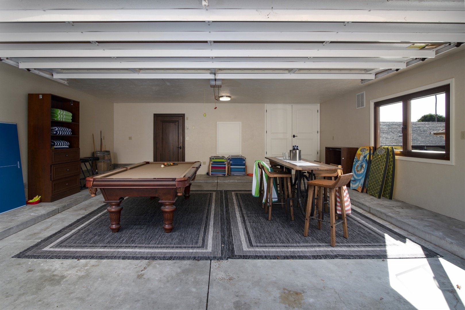 The Garage Game Room includes a pool table with convertible ping pong table top and a dining set to seat 8