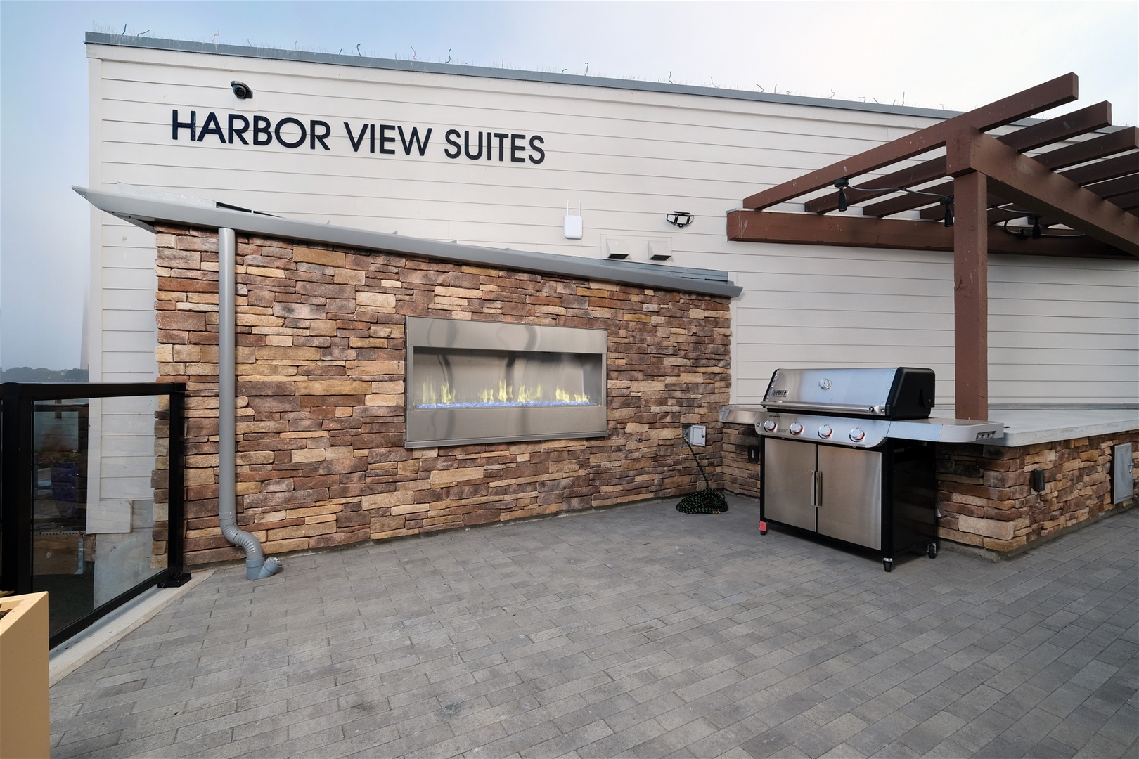 Outdoor fireplace and BBQ for guest use on the shared community patio