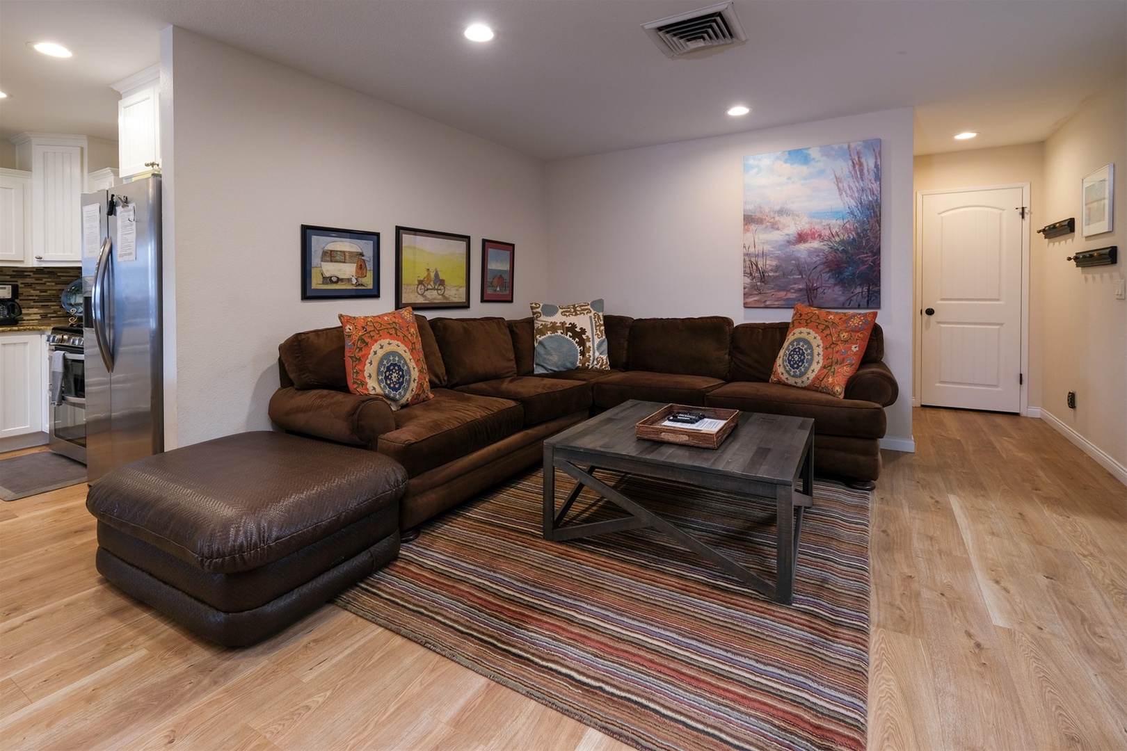 The den is adjacent and open to the kitchen and dining area.