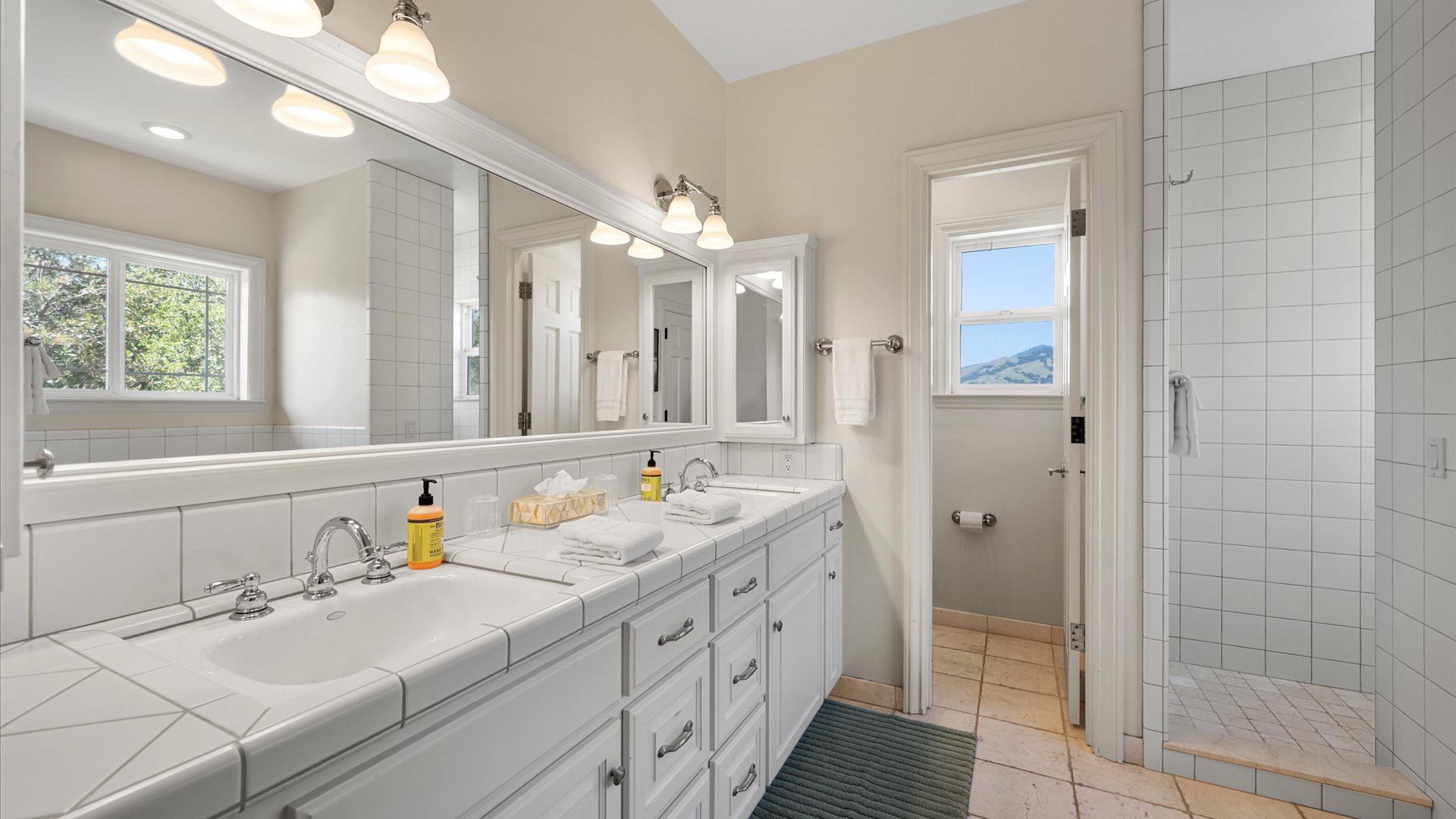 Ensuite bath features dual vanities, a spacious walk-in shower and seperate soaking tub