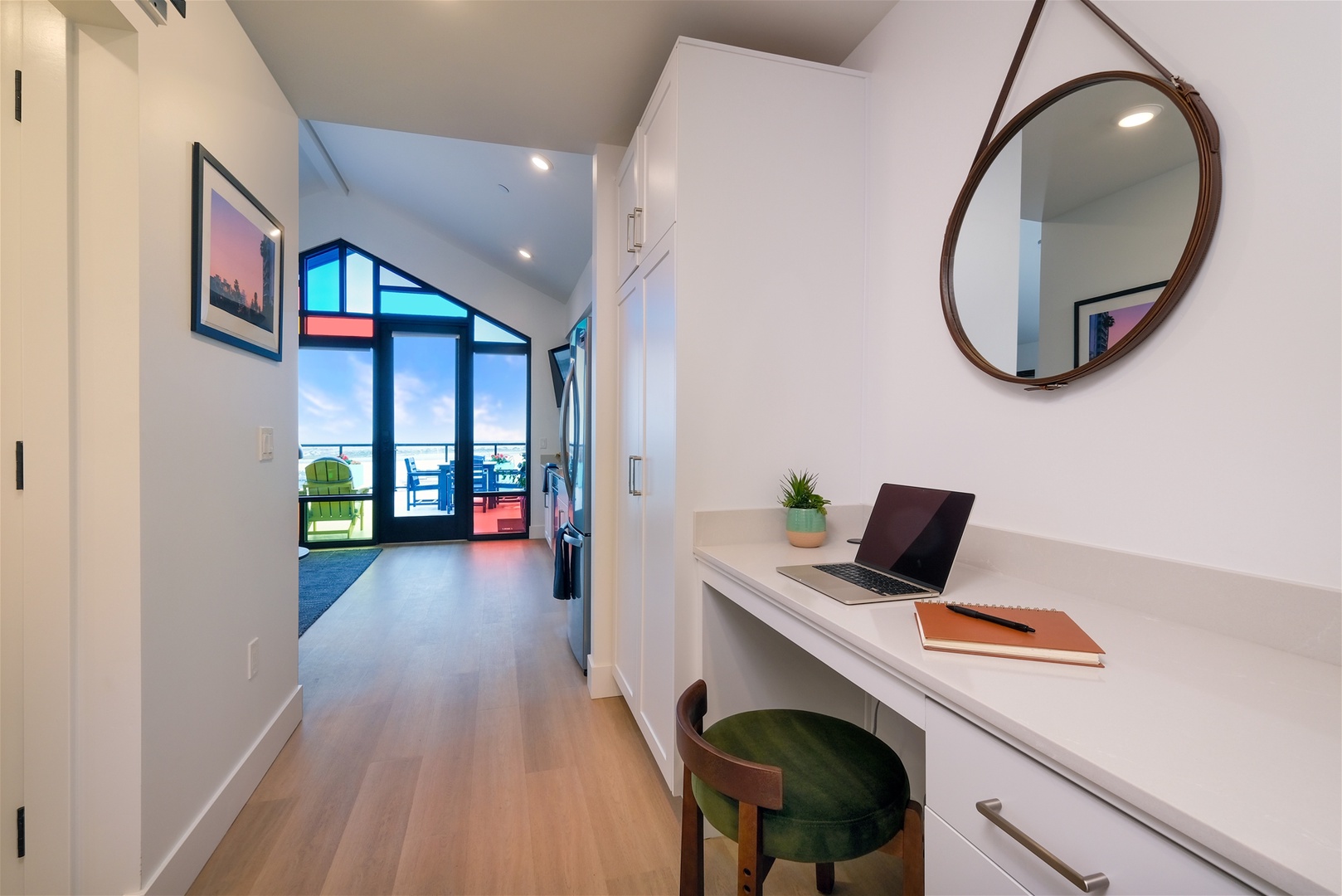 The hallway provides a dedicated working space with desk and charging station