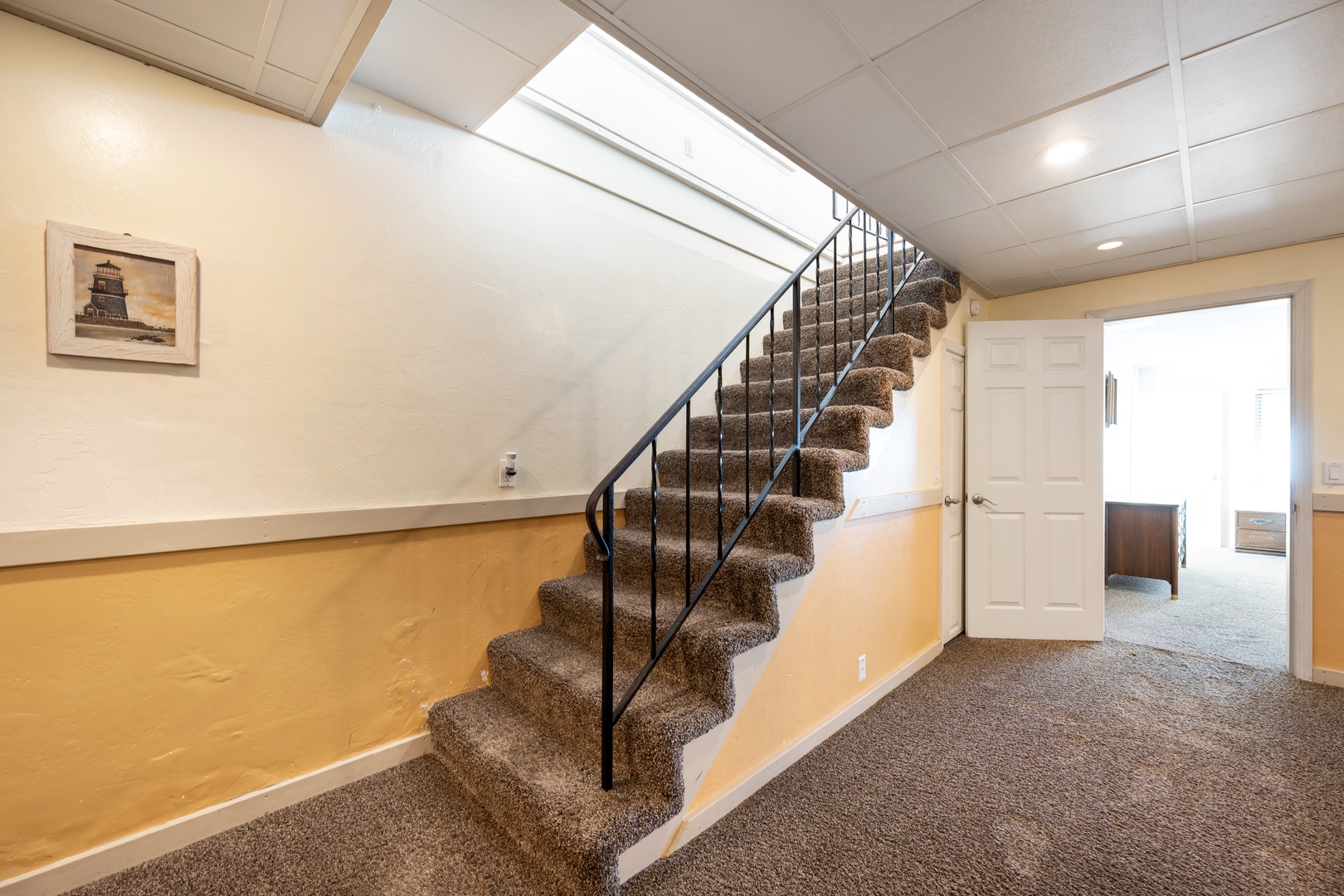 Stairs near the front doors take you down to the bonus room and additional 2 bedrooms