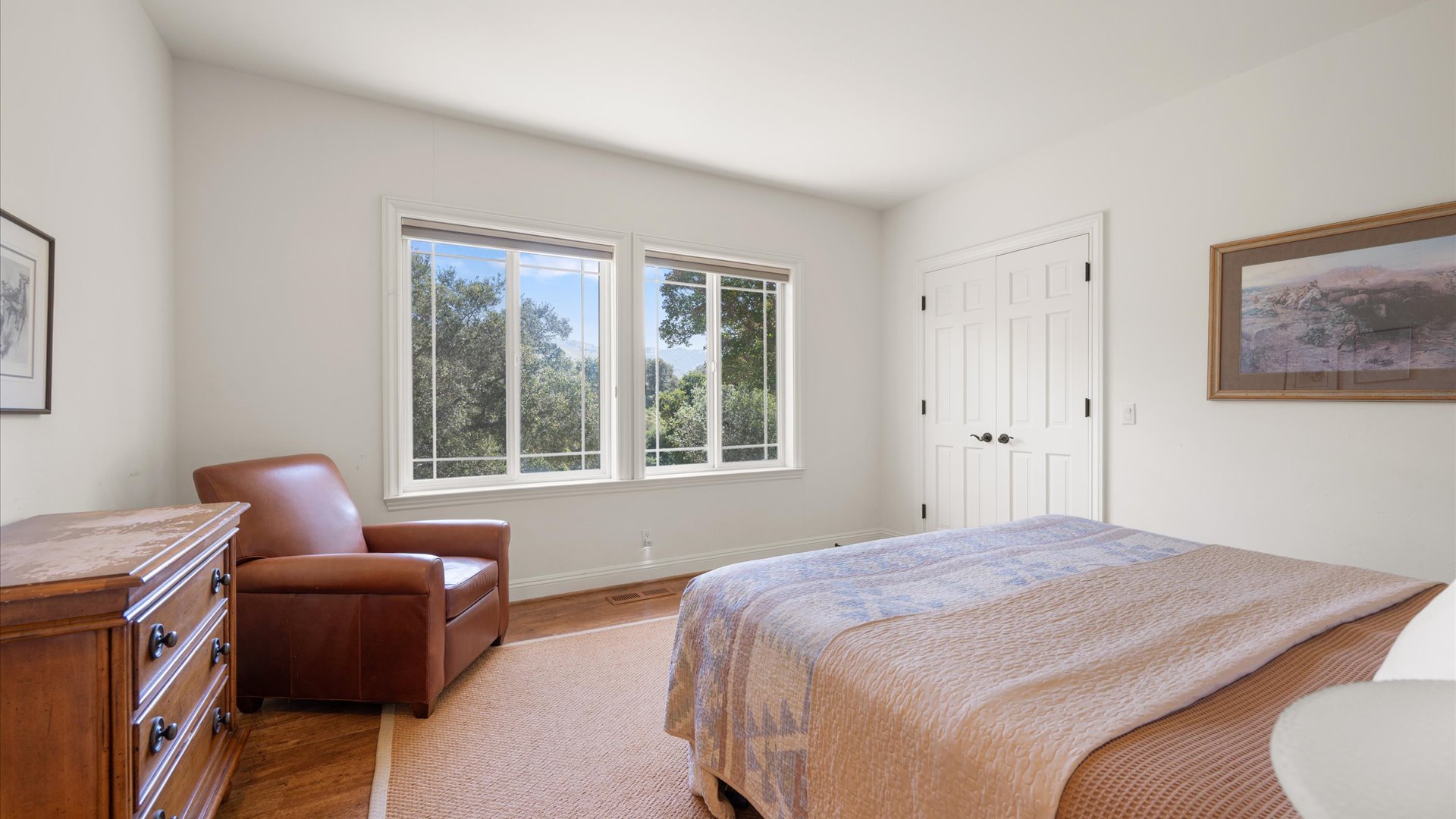 The East King bedroom features nature lighting and greenery views