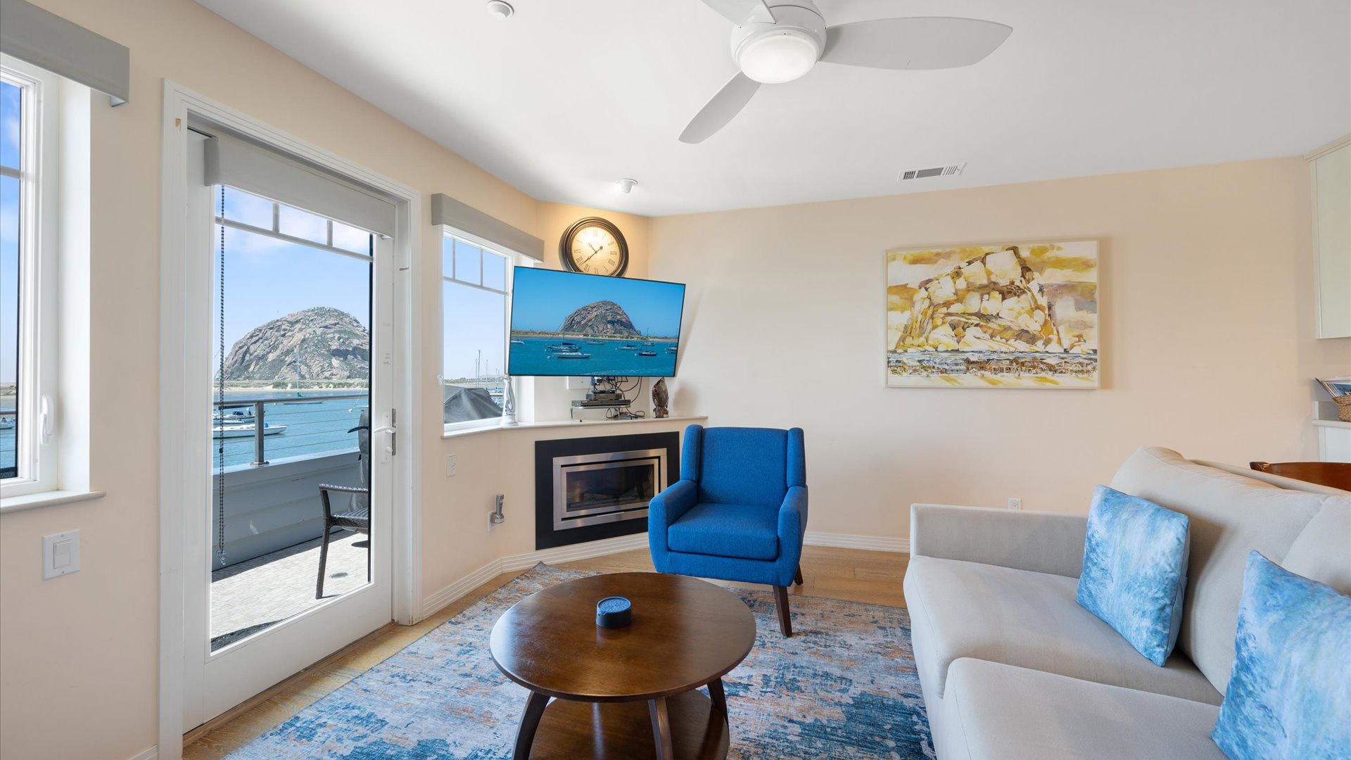 The living room has access to the balcony plus fireplace, flat screen tv, and stellar views