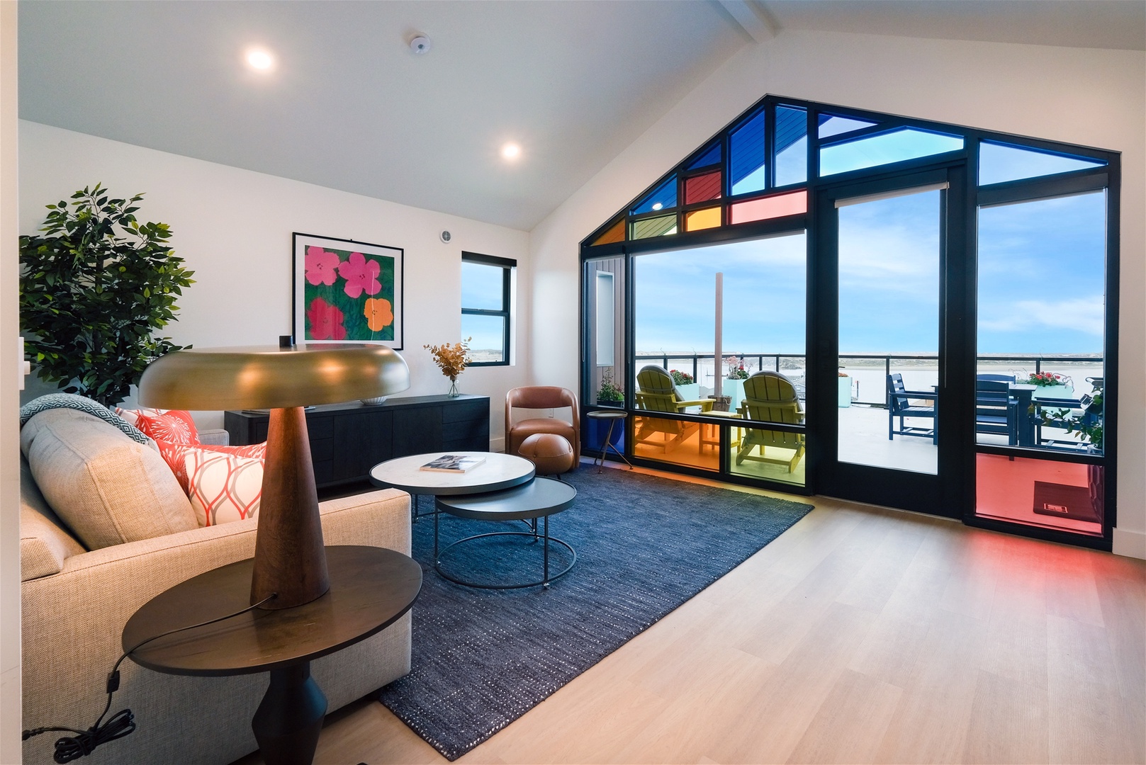 Enjoy light pouring through avant-garde windows in living room and kitchen spaces