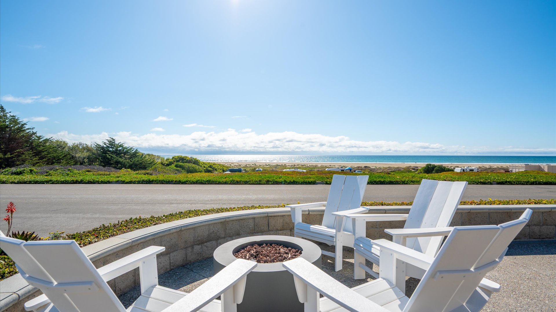 The property offers a stunning coastal setting with direct views across the street to the ocean, surrounded by lush greenery and accessible beaches.
