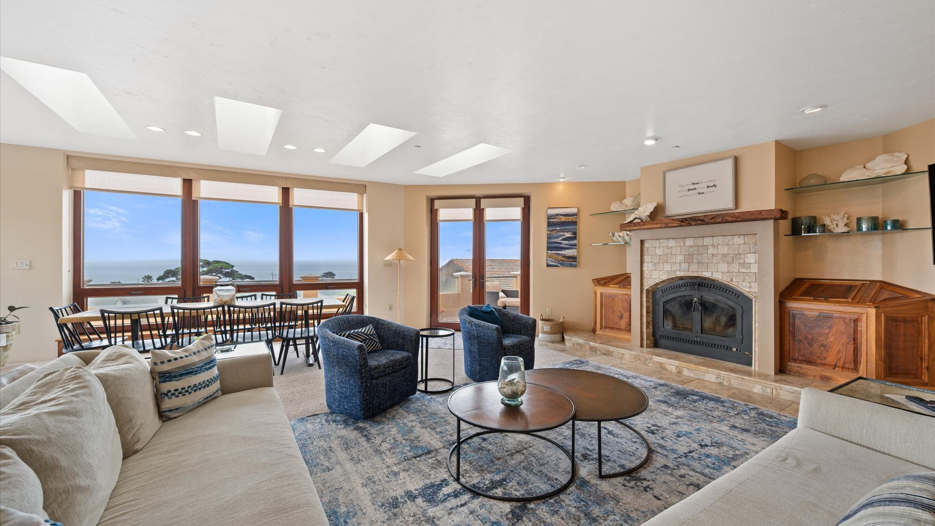 The living room boasts floor to ceiling windows offering gorgeous views of the coastline
