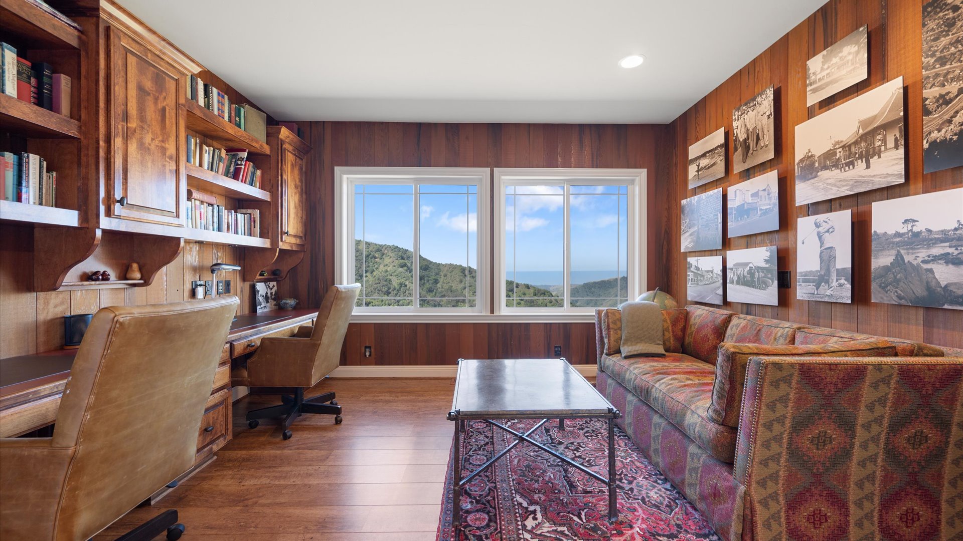 The den/office space features gorgeous views complete with a work station and a sleeper sofa as a bonus sleeping space