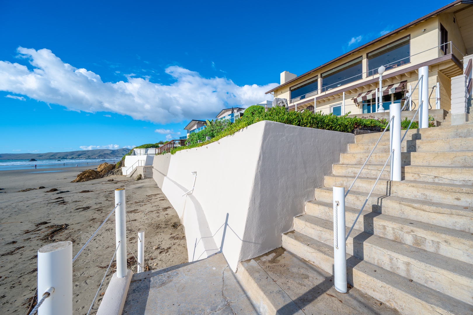 Private stairs from the back deck take you down the sand