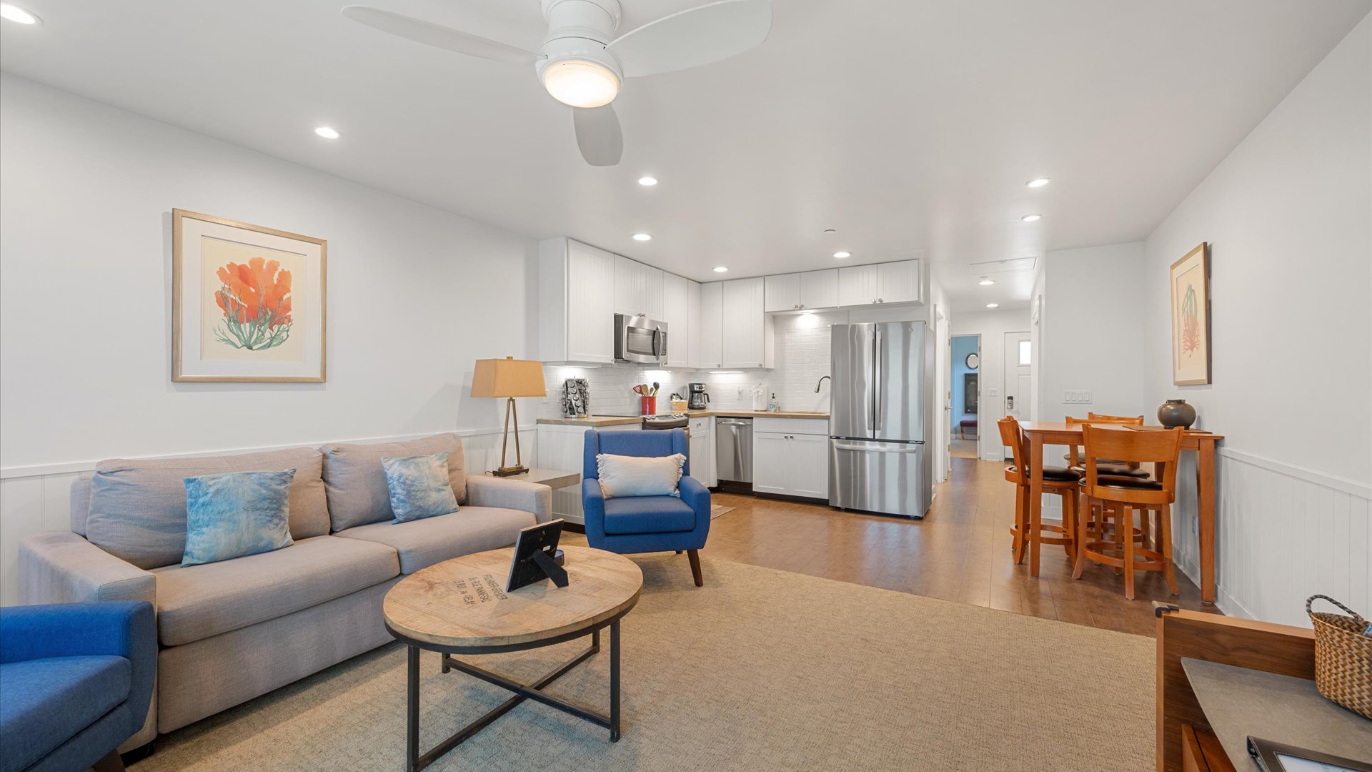 The living room has an open floor plan and there is a dining area for 4.