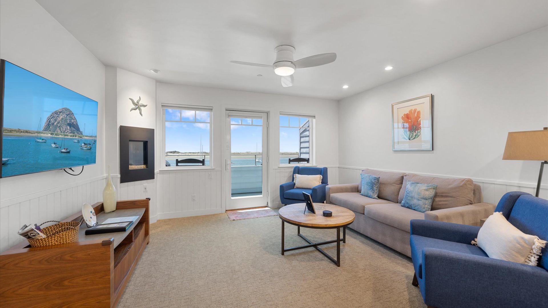 The living room includes a large flat screen tv and a fireplace.