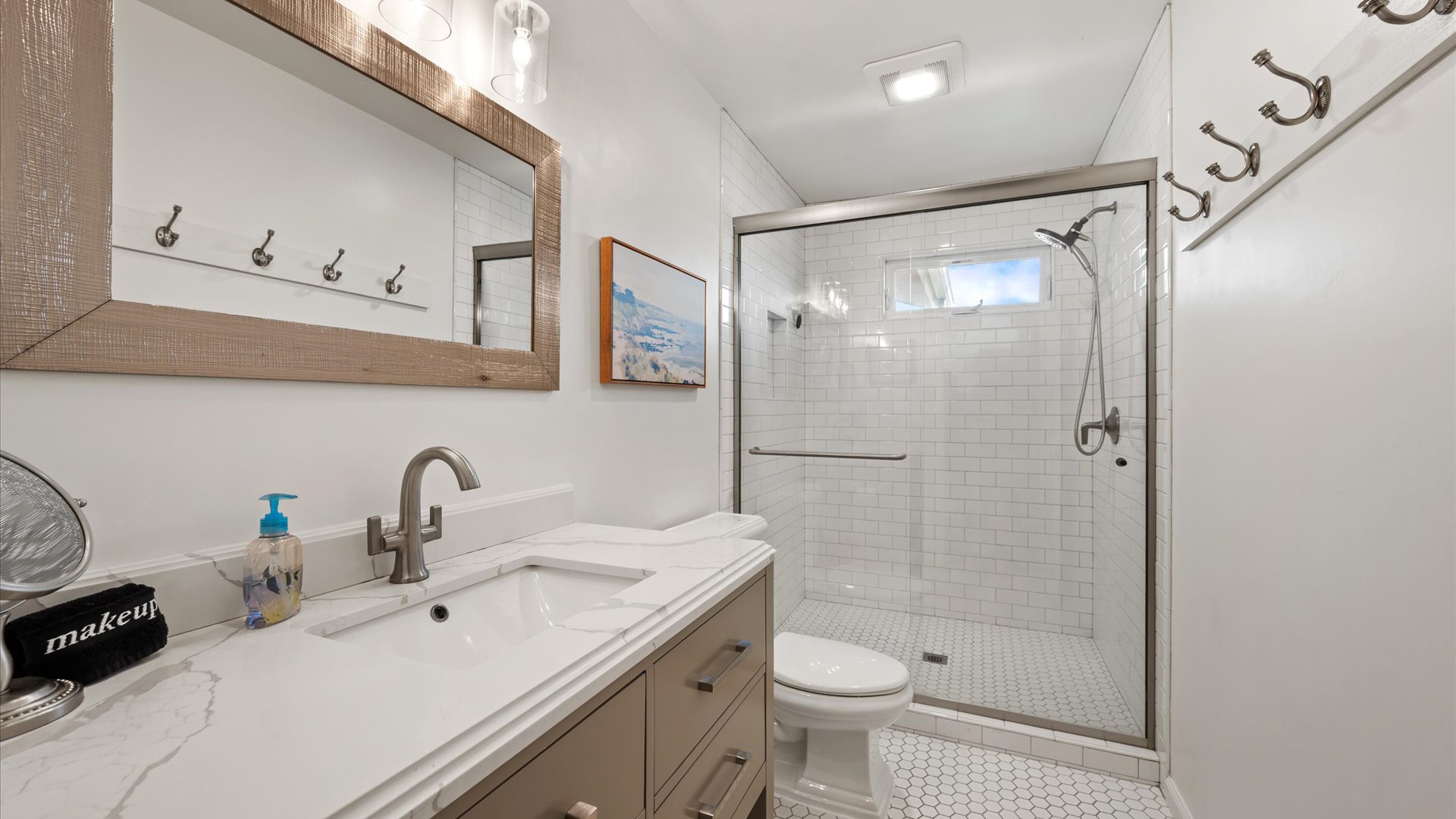 The hall bathroom is shared by the 2nd and 3rd bedrooms and features a step in shower