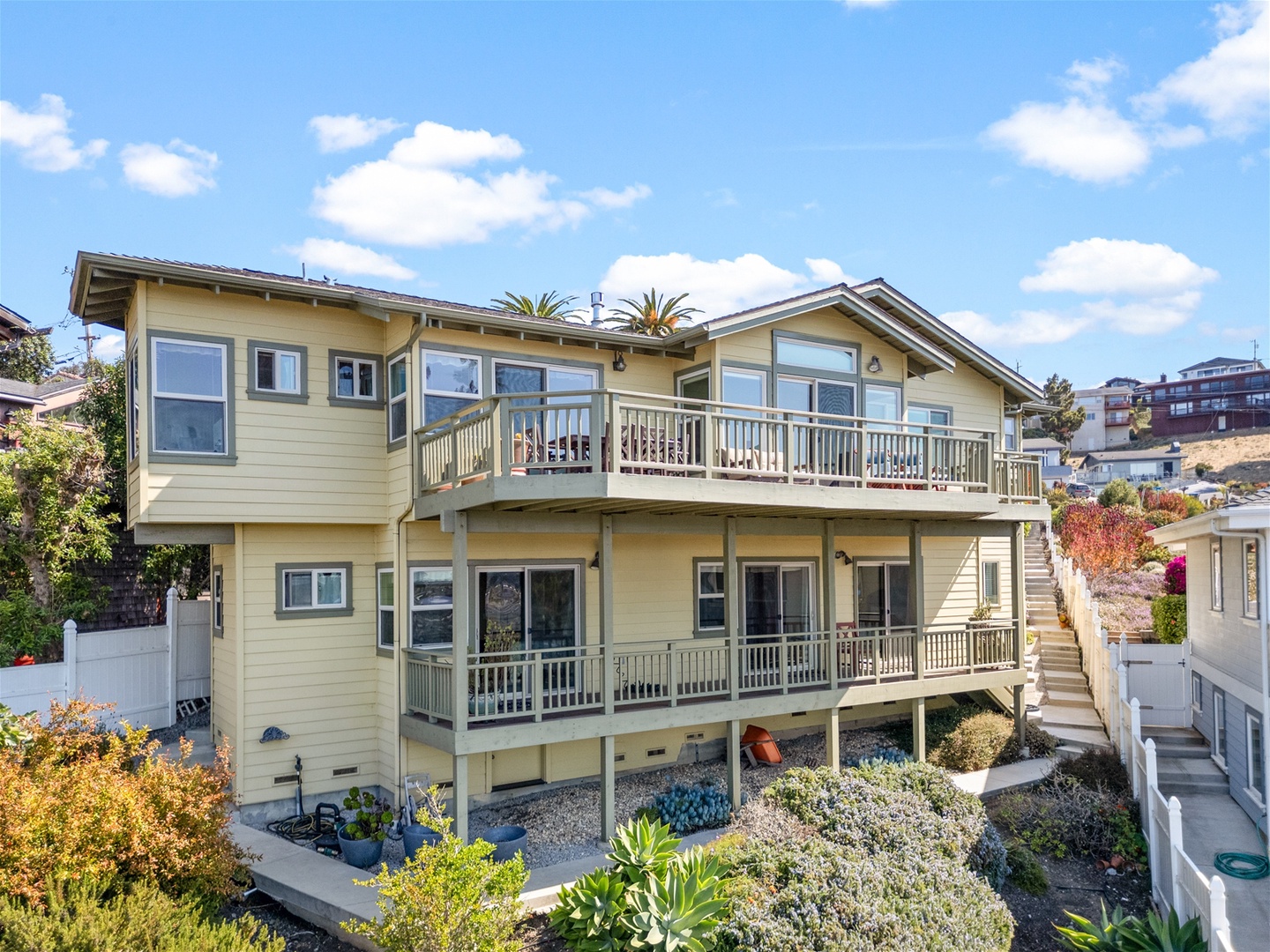 The well maintained and beautiful landscaped side yard has steps down to the back yard area and storage room where you can find beach chairs and toys.