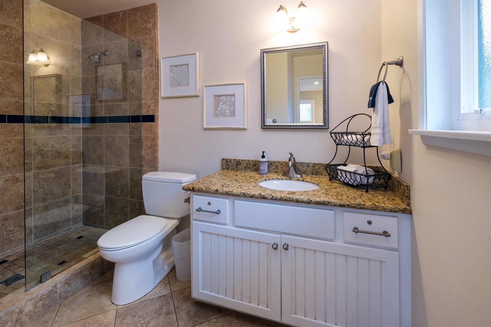 The master bathroom has a beautifully tiled step-in shower.