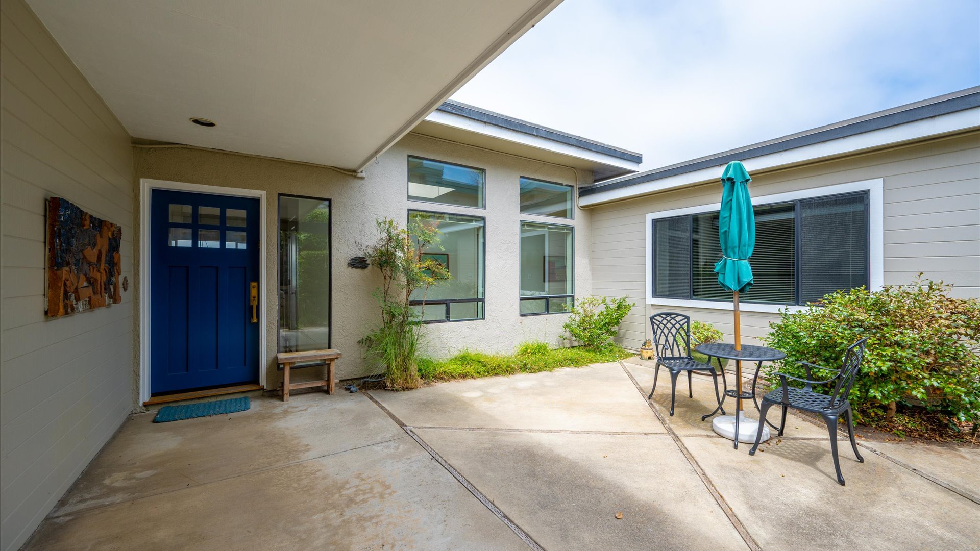 The sun soaked front courtyard welcomes you with a striking artistic touch