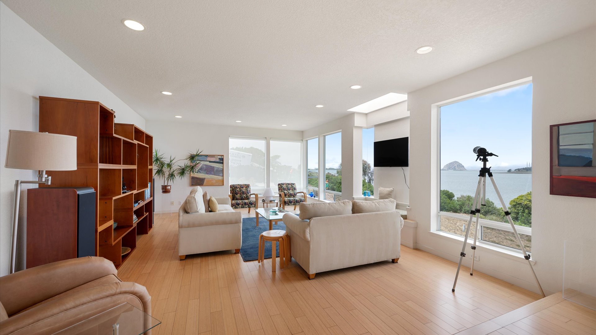 Unwind in your light-filled living room where panoramic windows frame breathtaking coastal views.