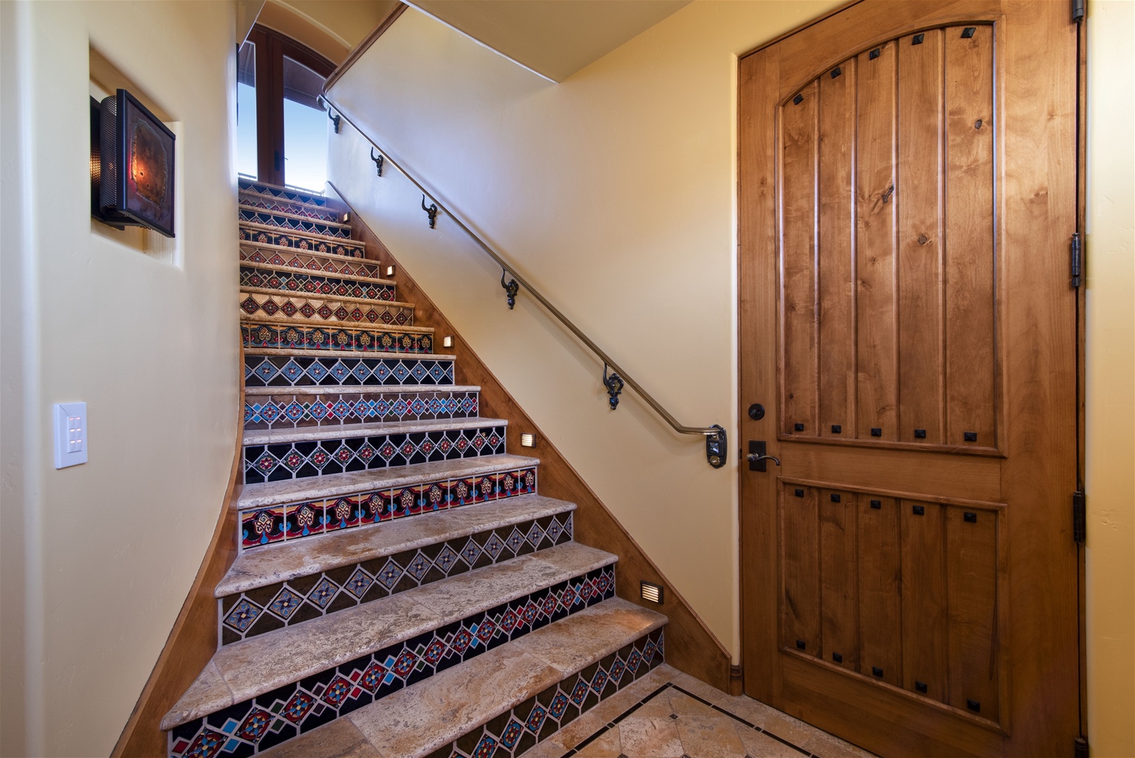 This stunning staircase brings you upstairs, the tiles are inspired by Hearst Castle