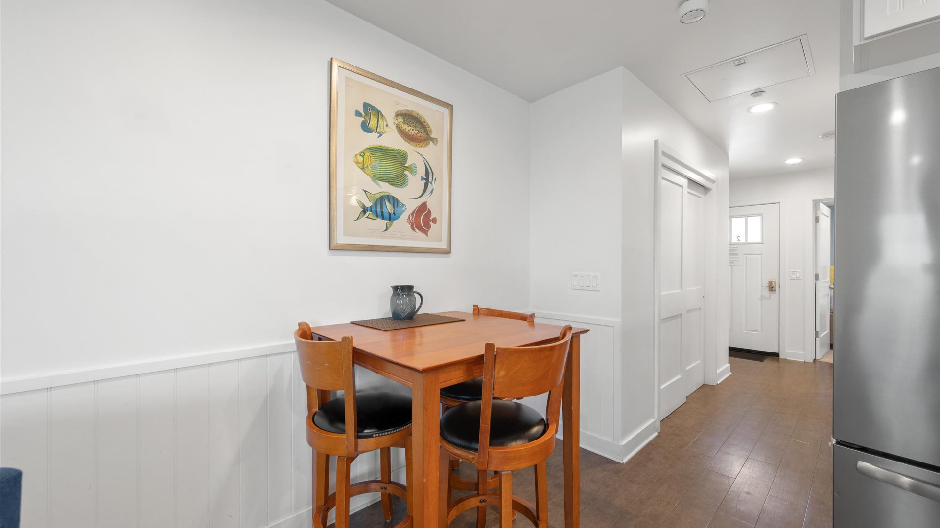 The dining area offers seating for 4 and is adjacent to the living room and kitchen.
