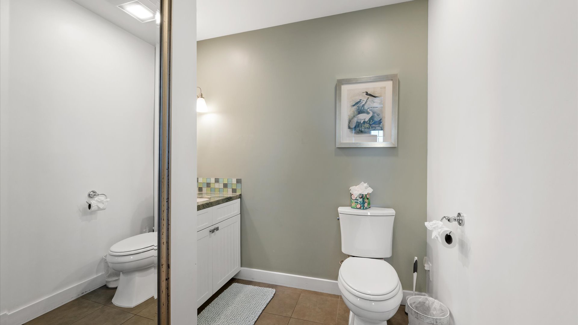 Half bath is off the living room and is spacious with beautiful touches.