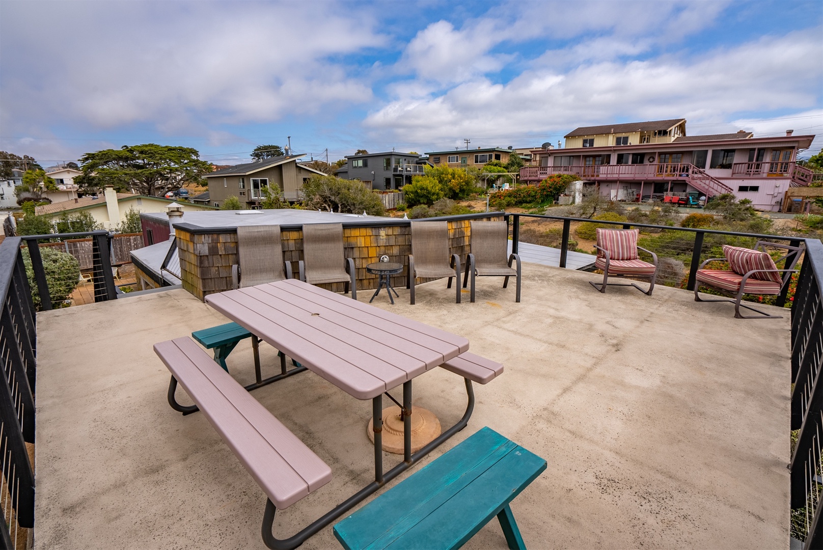 The rooftop patio features a picnic table to enjoy meals while taking in views.