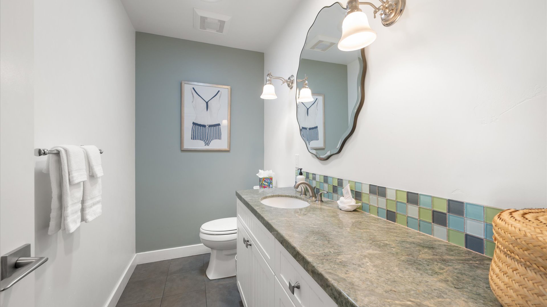 The half bathroom is large and available for anyone sleeping in the living room.