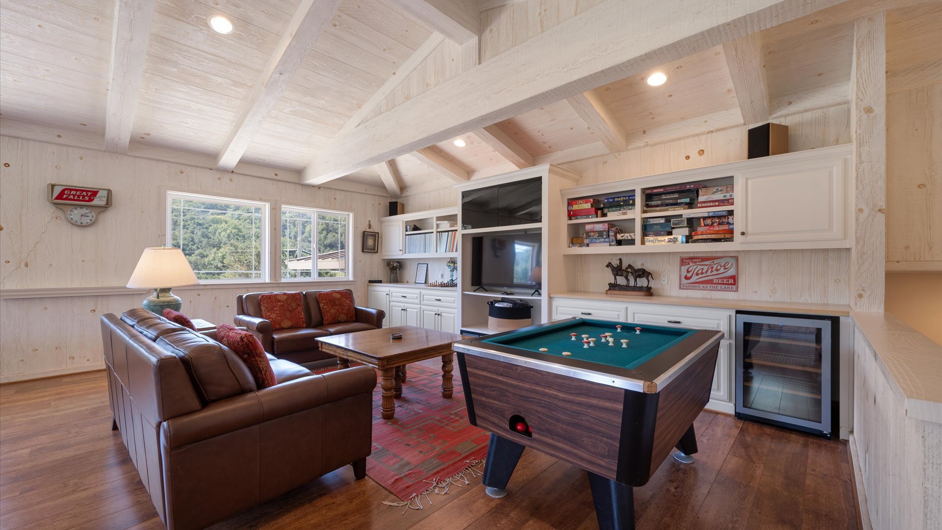 Game room ready to be enjoyed with flat screen tv, plush seating, ping ping, bumper pool, and traditional pool table