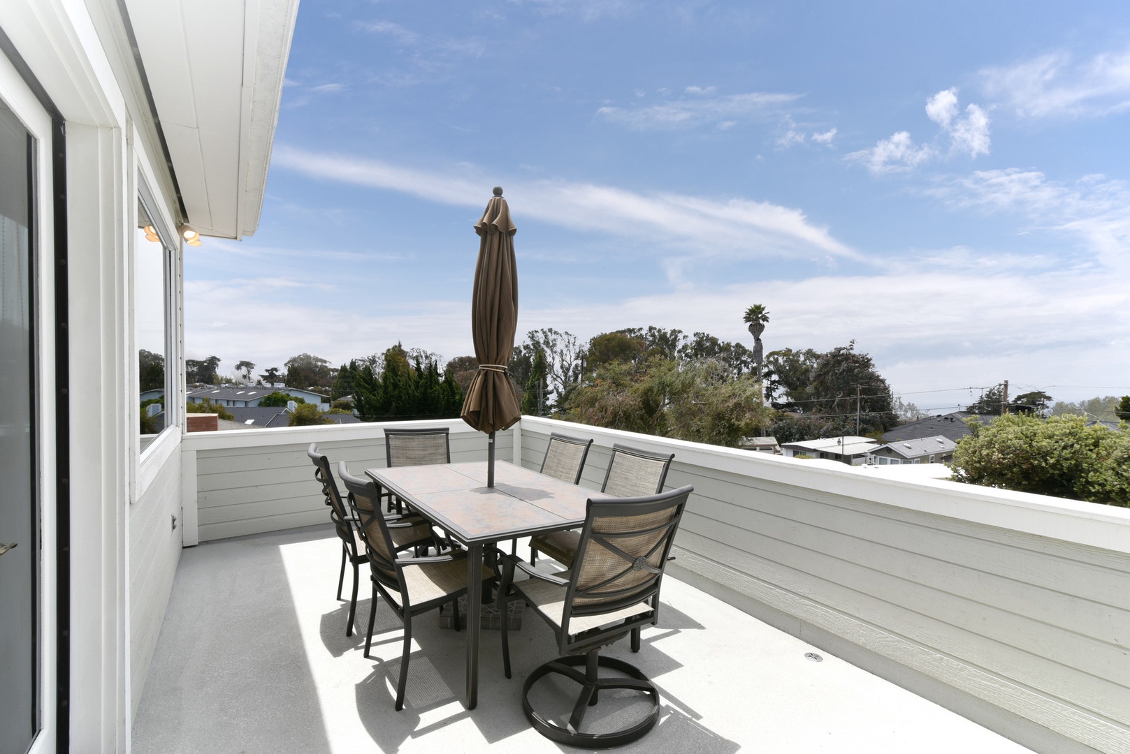 The upstairs deck has awesome views in every direction.  The patio table and chairs and Weber grill create a great outdoor dining space.