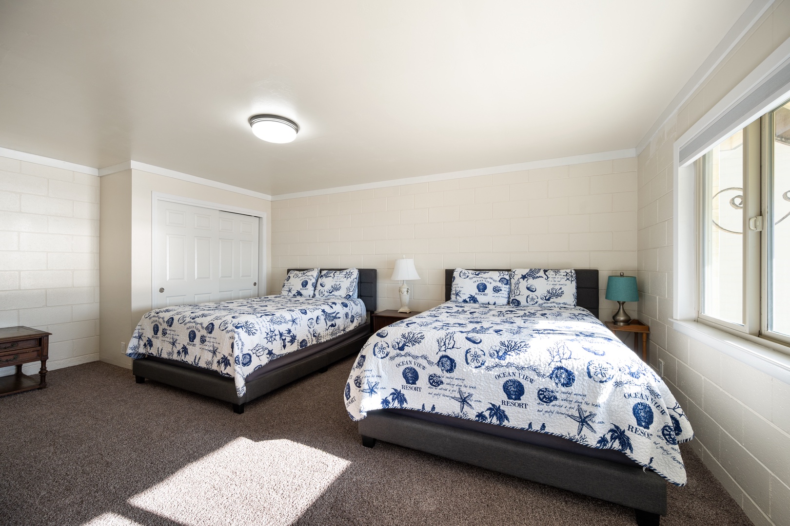 Second downstairs bedroom with 2 double beds, access to back patio and downstairs bath