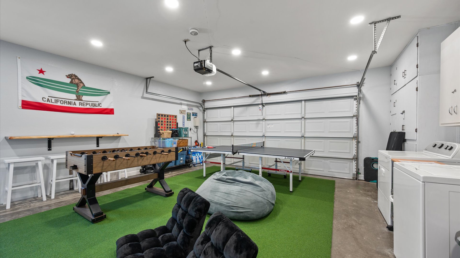 The garage has been turned into a game room, fully stocked for hours of fun. Washer and dryer also available for guest use