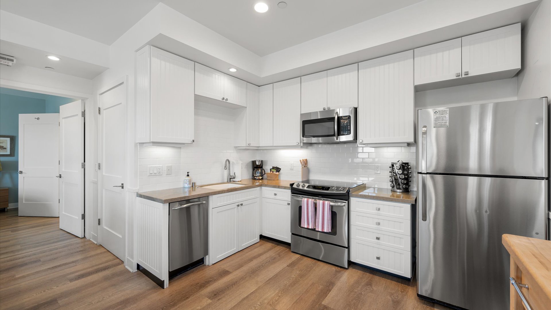 The kitchen has a full size refrigerator and stove and is stocked with everything you need to cook at home.