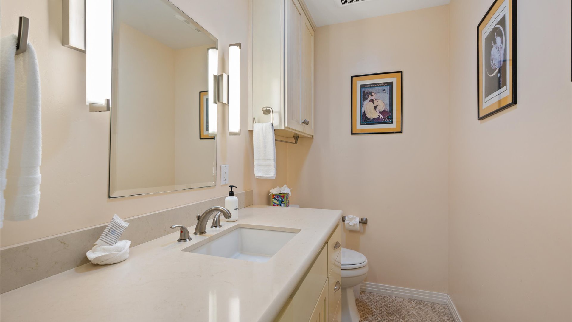 The half bath is easily accessible from the living room and provides an extra place to get ready for your evening out.