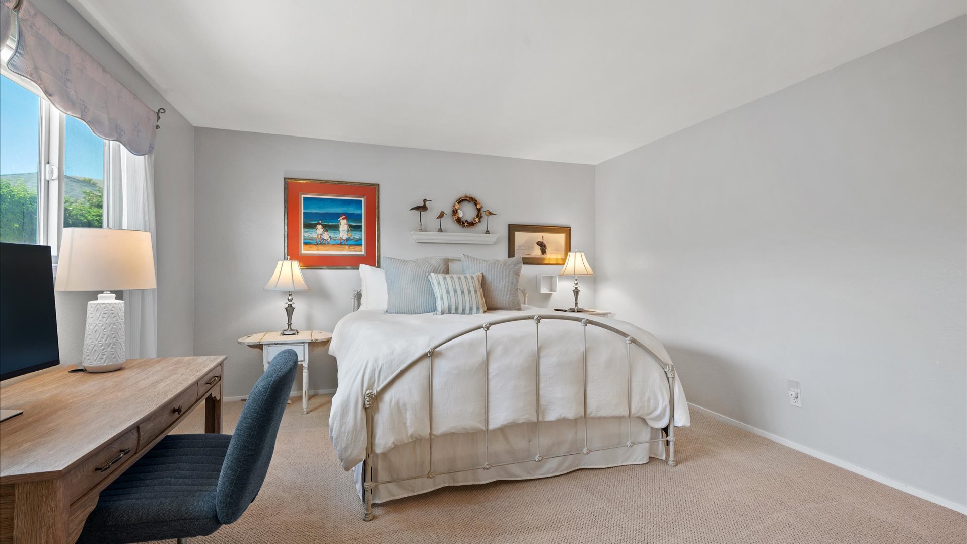 Dedicated work from home space with desk and monitor also in the master bedroom