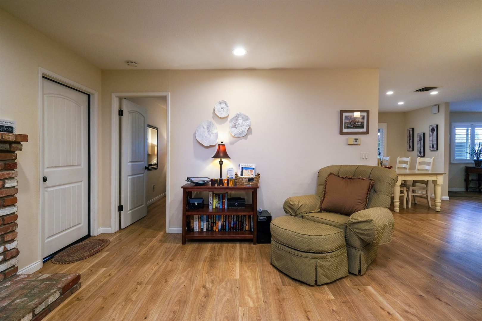 Open layout of the home, doors to the garage and third bedroom off Den