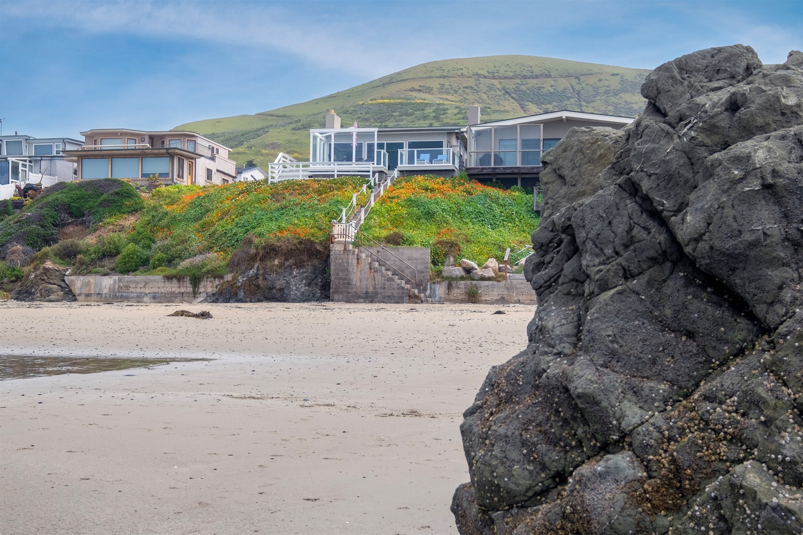 The beach is your backyard at this vacation home