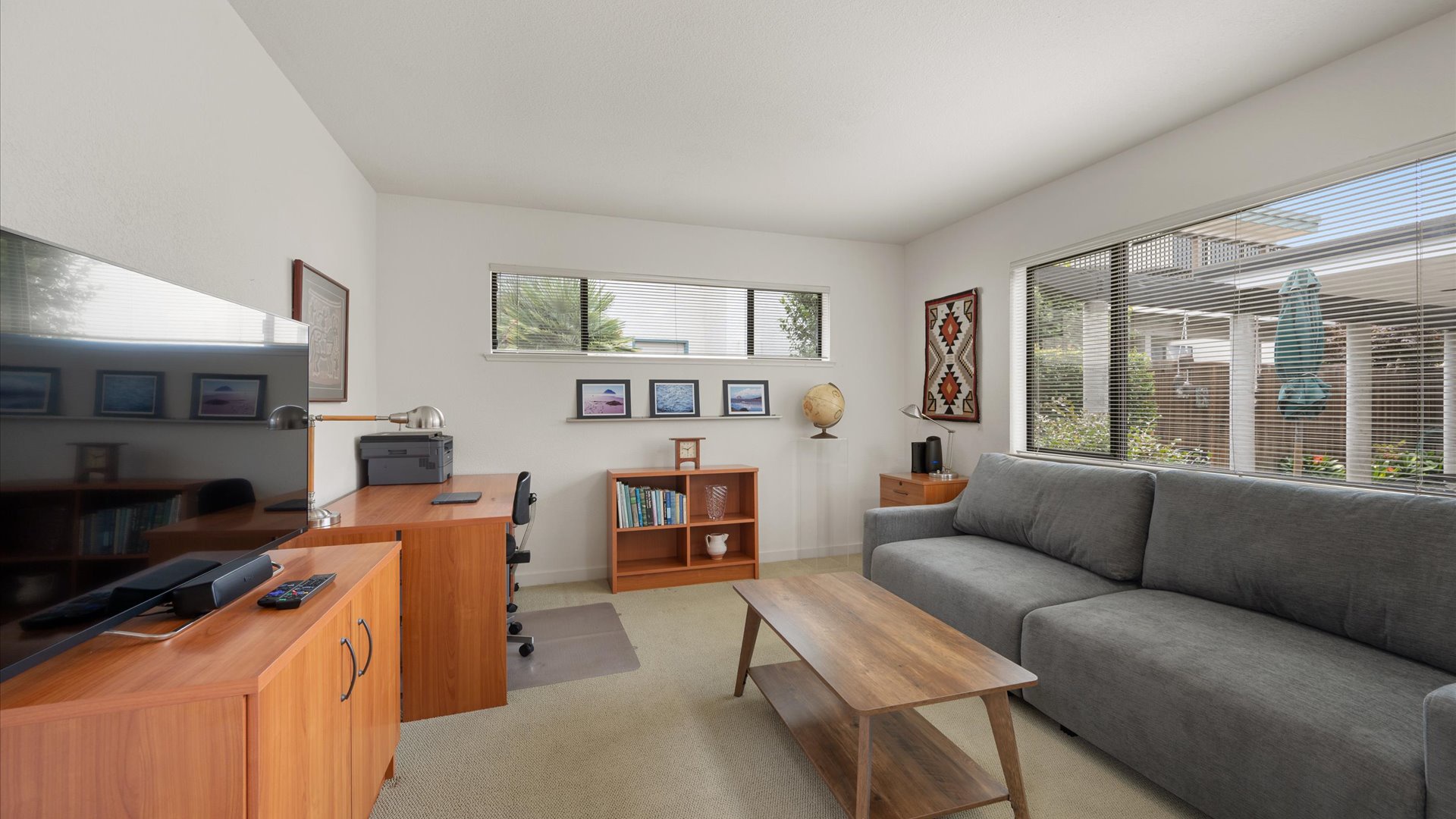 3rd Bedroom/Den features a Serta Gabi convertible sleeper sofa that transforms into a queen bed or one/two lounge chairs, a desk, and flat screen tv.