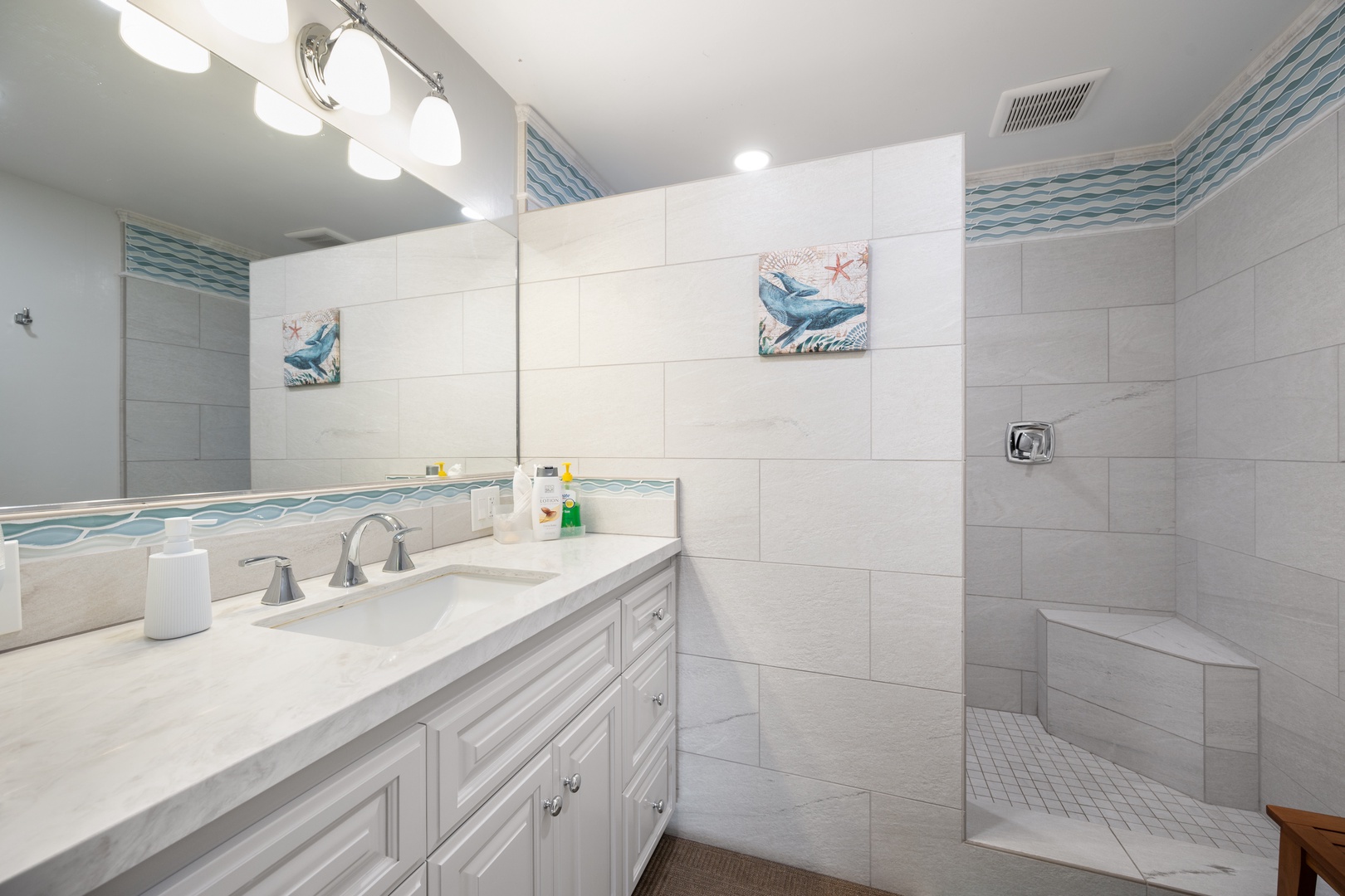 Downstairs bath has been gorgeously updated with step in shower