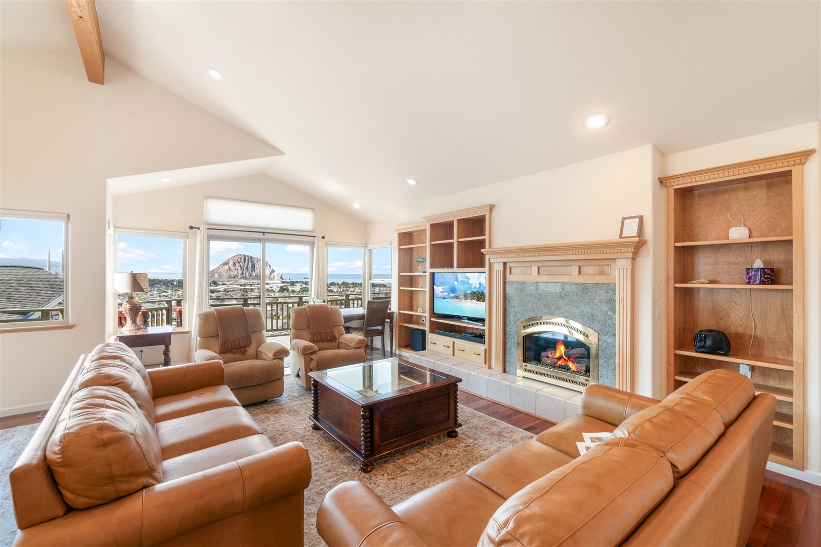 This inviting living room has comfortable seating, amazing views and a fireplace.