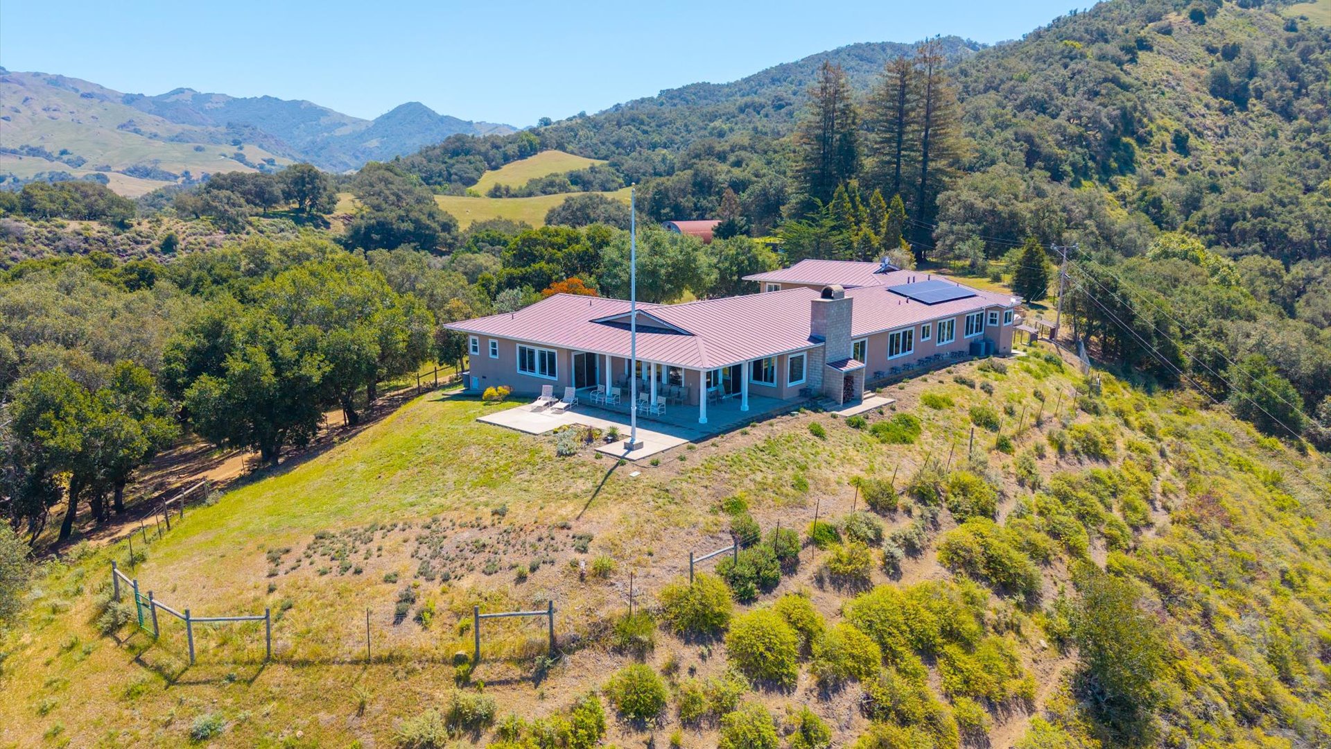 Arial view of the back of the home, gorgeous greenery in all directions