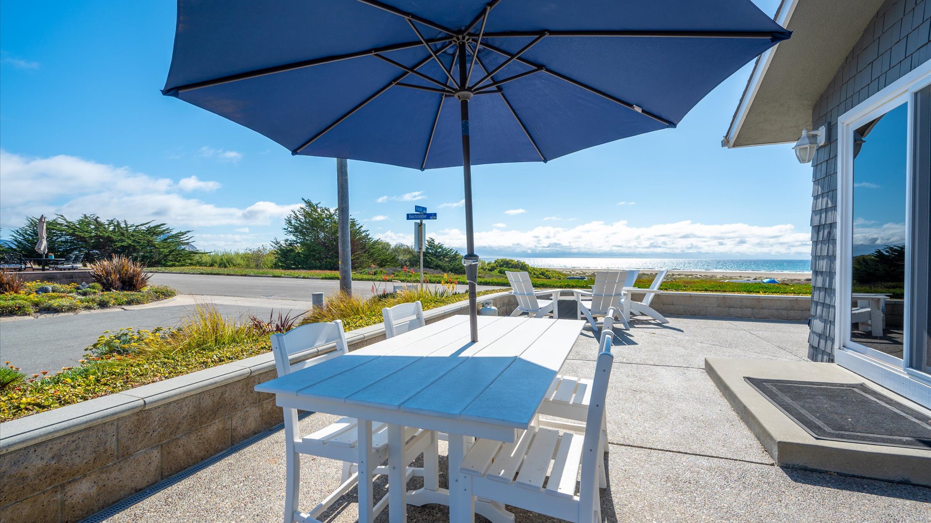 An outdoor table on the oceanfront patio overlooks the Morro Strand Beach