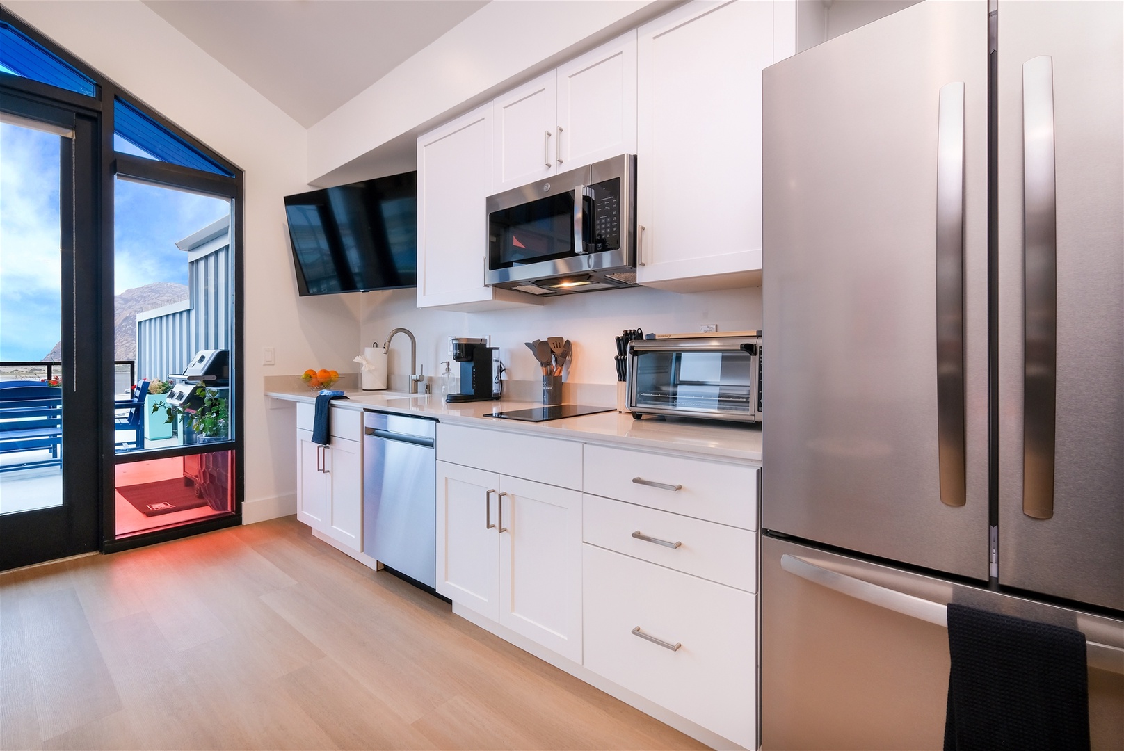 Kitchen includes full-size fridge, microwave, electric double burner, toaster oven, Keurig, and dishwasher
