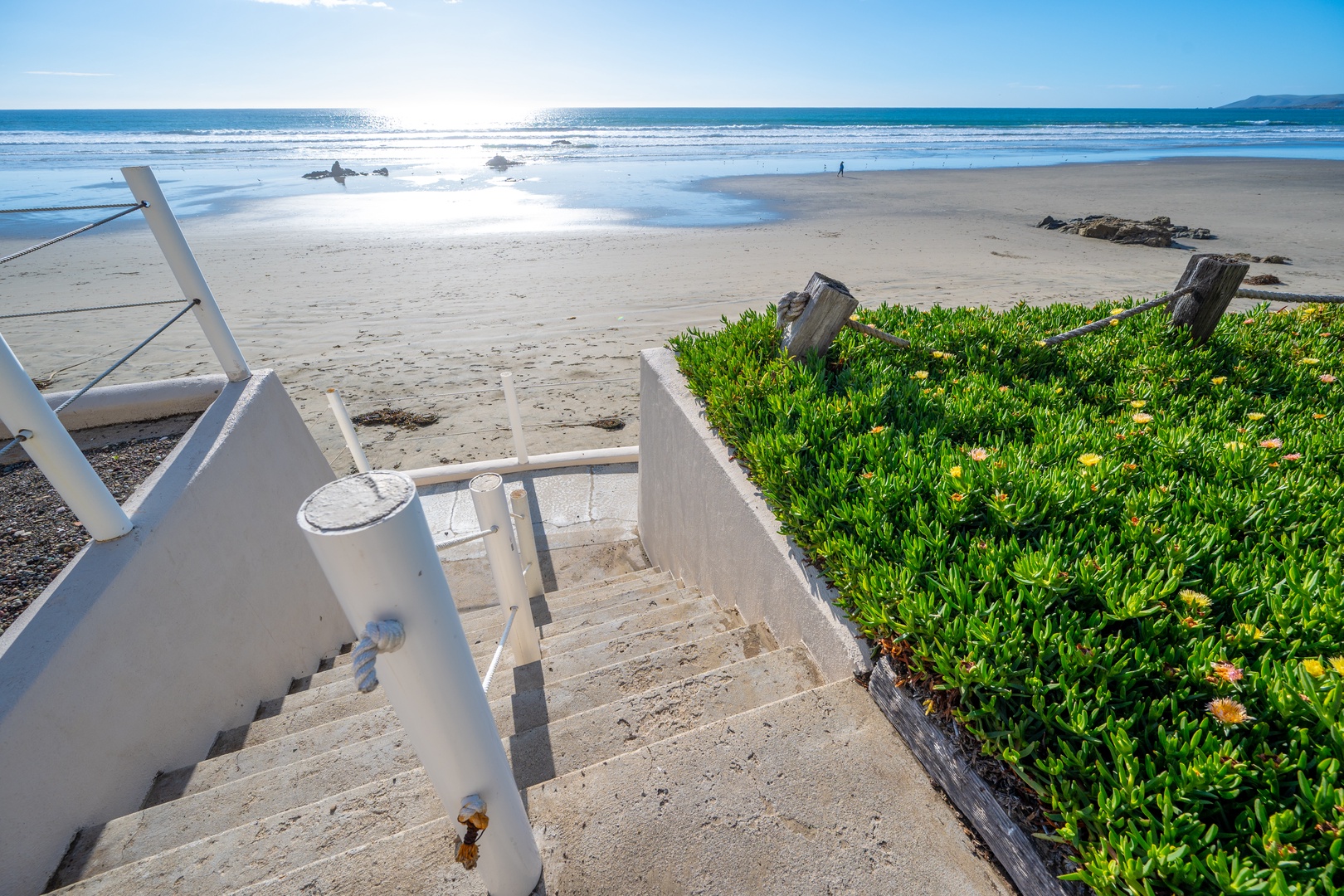 Private stairs from the back patio take you down the sand