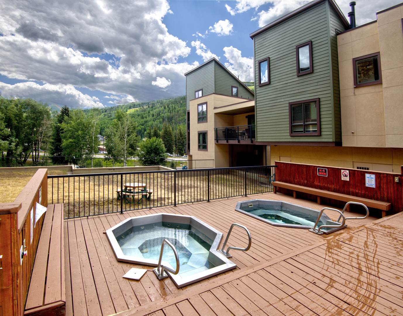 Unwind in bubbling hot tubs on this mountain deck, where forest views and fresh alpine air create your perfect evening retreat.