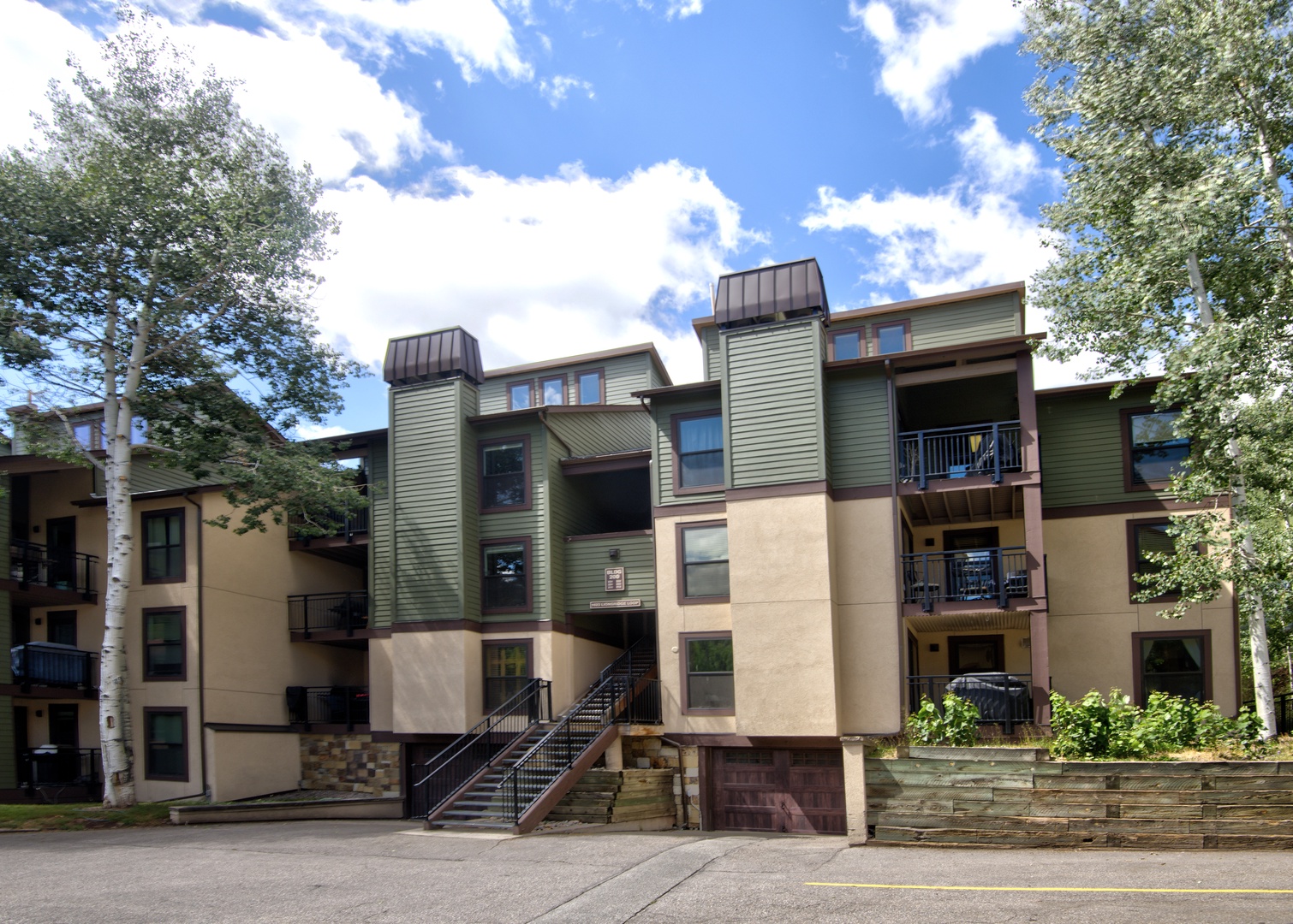 Modern mountain property featuring multi-level architecture with contemporary design and natural stone accents.
