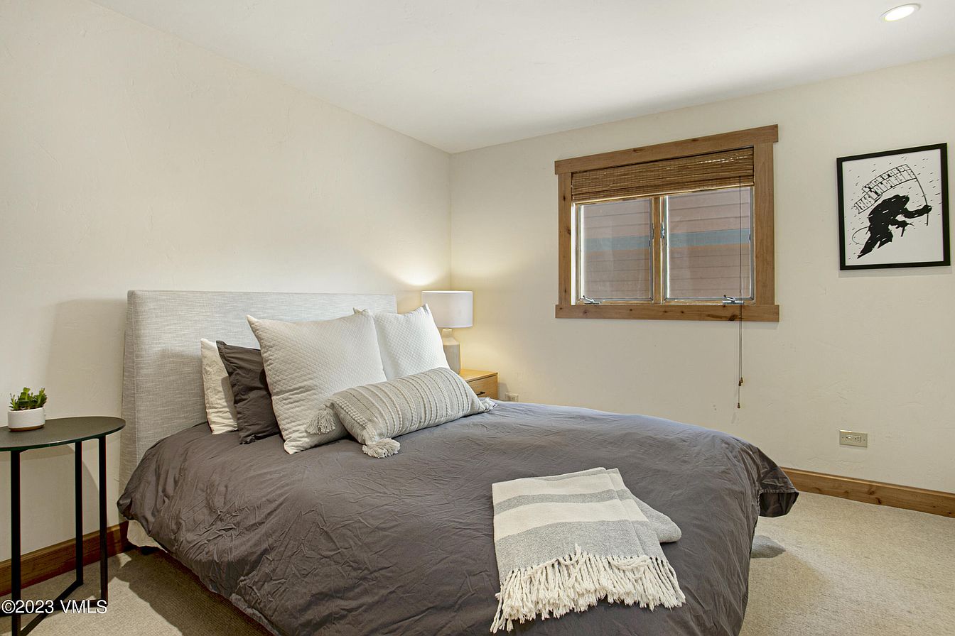 Settle into your peaceful retreat with a cozy queen bed, soft linens, and warm natural light streaming through your window.