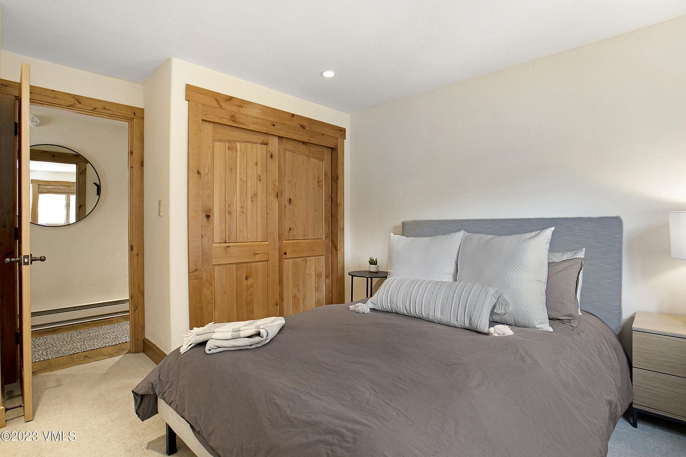 Sink into plush bedding and wake up refreshed in this peaceful bedroom, where warm wood tones and clean lines create your mountain retreat sanctuary.