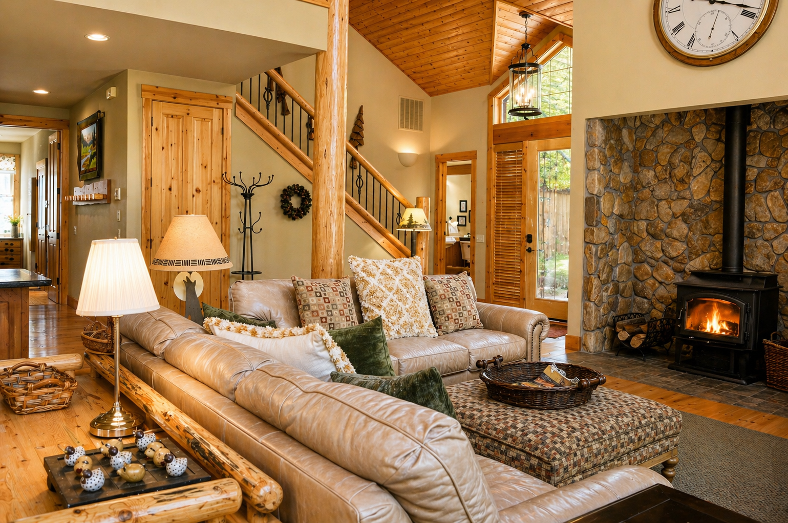 Sink into plush leather seating by the crackling stone fireplace, where rustic charm meets modern comfort in your mountain retreat.
