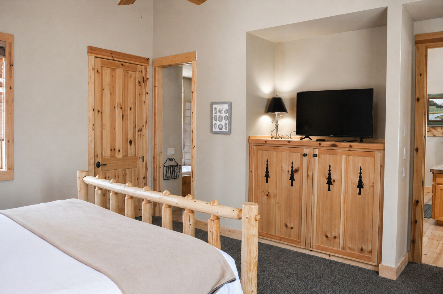 Unwind in your cozy mountain-themed bedroom featuring rustic wood furniture and modern amenities for the perfect alpine retreat.