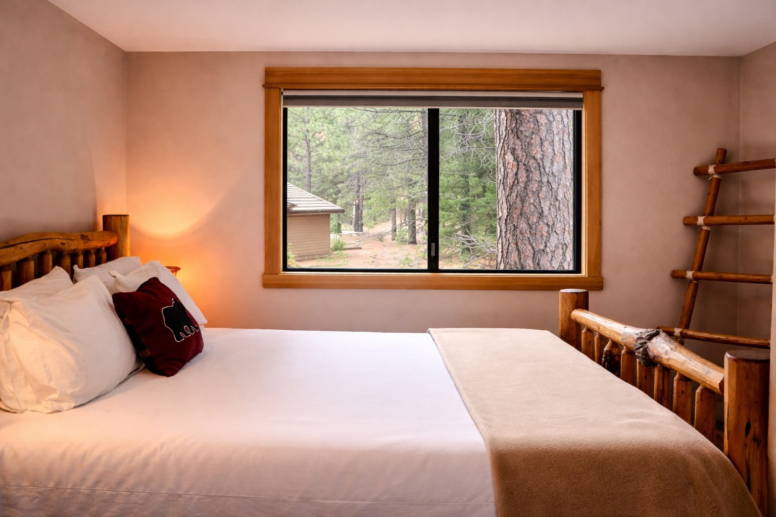 Wake up to forest views from your cozy bedroom, where warm wood touches and crisp linens create the perfect retreat.
