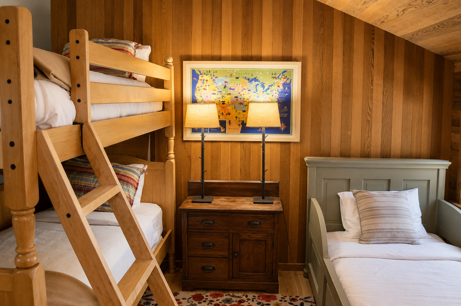 Your cozy retreat features a bunk bed and twin bed with plush linens, warm wood paneling, and soft ambient lighting—perfect for families or groups seeking comfort and togetherness.